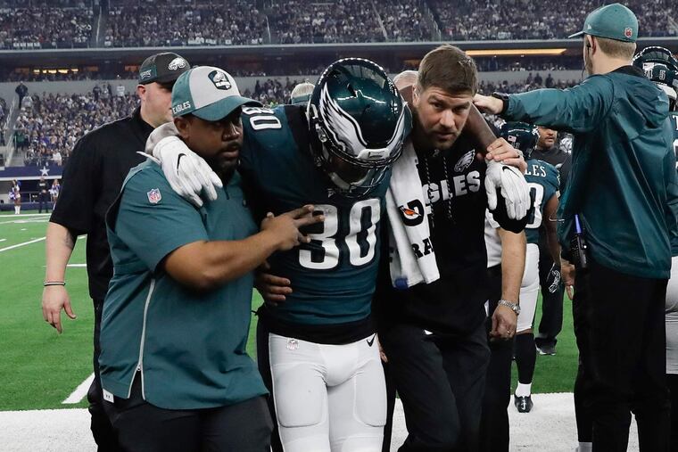 Corey Clement gets help leaving the field after injuring his leg during the Eagles' loss to Dallas on Sunday.
