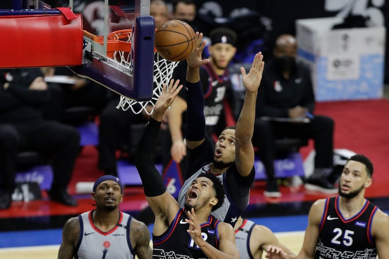 Sixers forward Tobias Harris lays-up the basketball past Washington Wizards center Daniel Gafford during the second quarter during game one of the Eastern Conference quarterfinals NBA playoffs on Sunday, May 23, 2021.