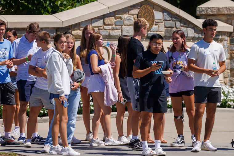 Villanova University students about to cross Lancaster Avenue at North Ithan Avenue on Friday, the day after their campus was roiled by a false active shooter alert.