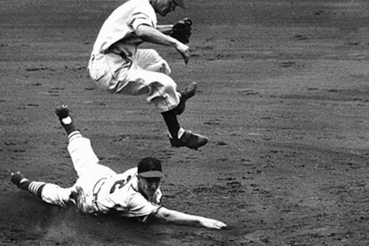 Athletics shortstop Eddie Joost leaps over the Cardinals' Red Schoendienst in an effort to complete a doubleplay during the All-Star game at Ebbets Field in 1949. (AP Photo)