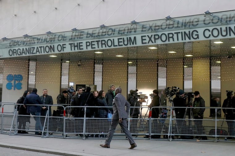 People stand in front of the headquarters of the Organization of the Petroleum Exporting Countries, OPEC, in Vienna, Austria.