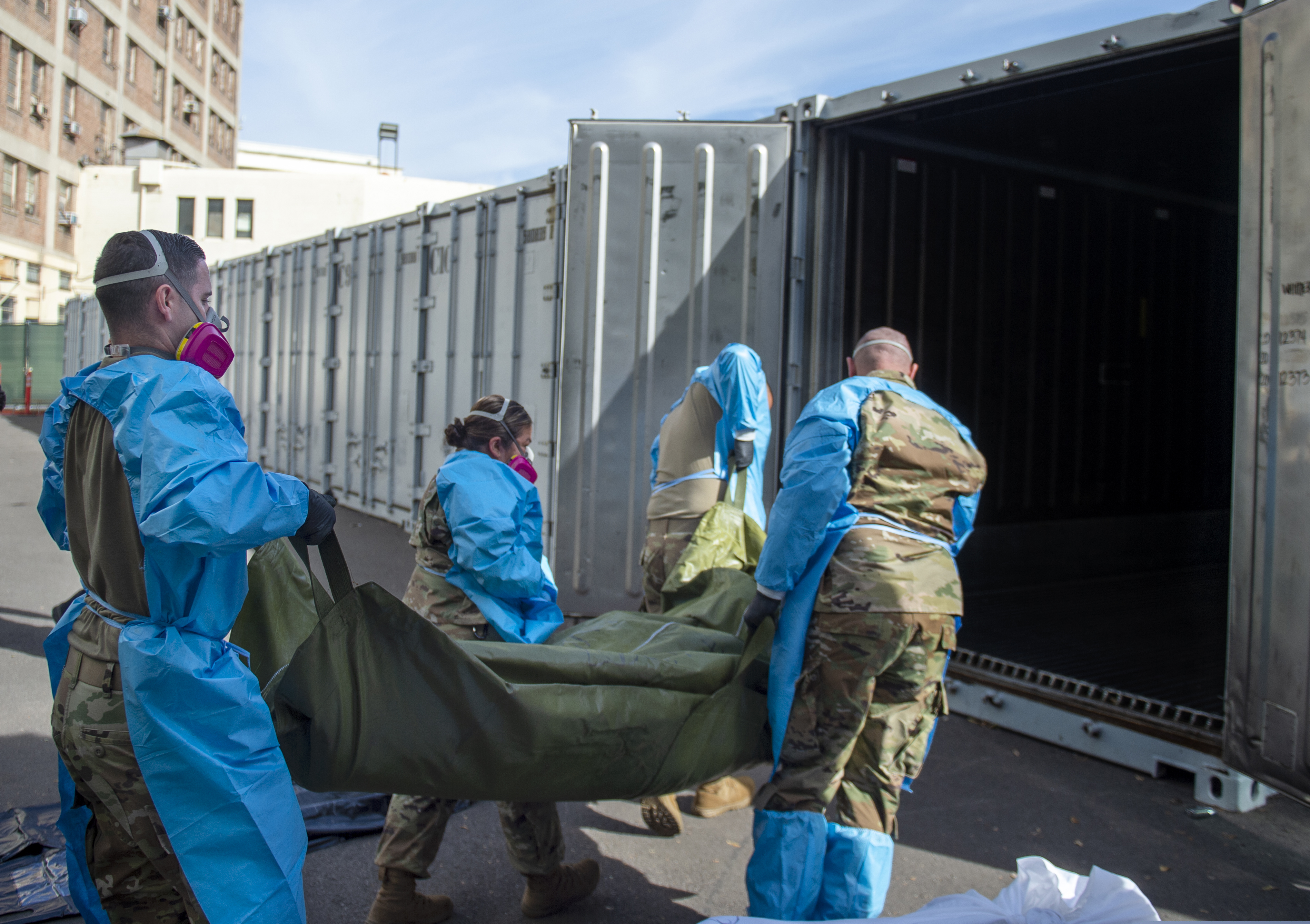 National Guard members assisting with processing COVID-19 deaths, placing them into temporary storage at the medical examiner-coroner's office in Los Angeles.