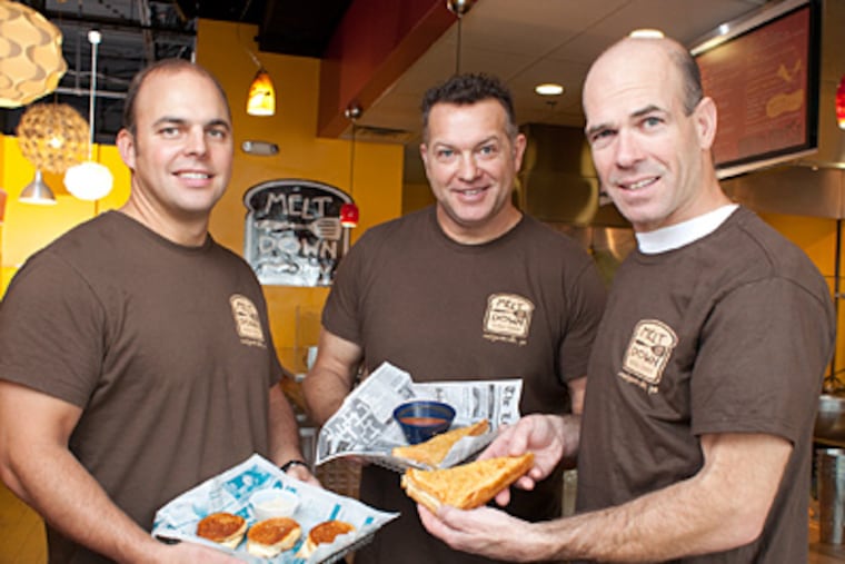 Owners of the grilled cheesery (from left) Tom Stuart, Pete Howey, and Aaron Nocks, with Brie Melt Sliders and the Baja Melt. (Ed Hille / Staff Photographer)