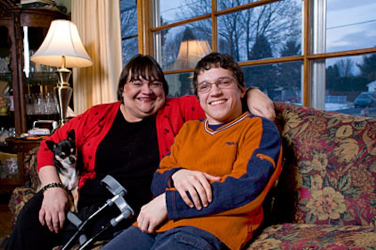 Born in Moscow with cerebral palsy and abandoned into the horrors of the Russian orphanage system, John Lahutsky was adopted by Paula Lahutsky and has grown up to be an exceptional student. (Ed Hille / Staff Photographer )