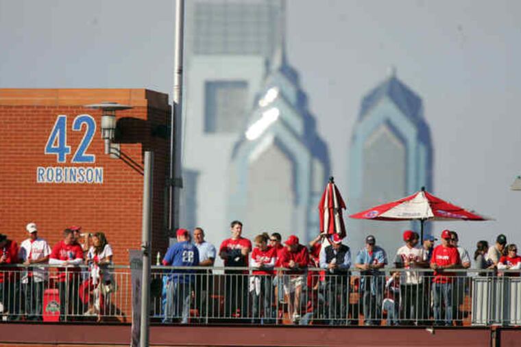 Phillies fans atop Citizens Bank Park, with the city's tallest towers, in 2018.