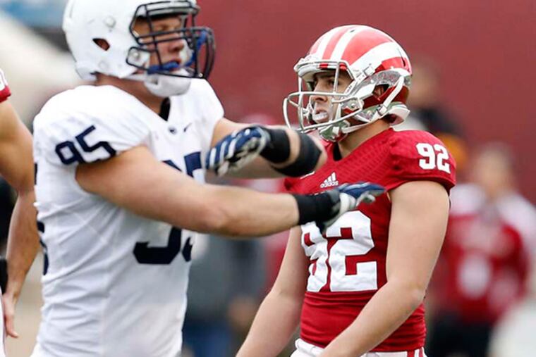 Penn State defensive end Carl Nassib (95) signals a missed field goal as Indiana place kicker Griffin Oakes (92) reacts after a fourth quarter field goal attempt in an NCAA college football game in Bloomington, Ind., Saturday, Nov. 8, 2014. Penn State won the game 13-7. (AP Photo/Sam Riche)