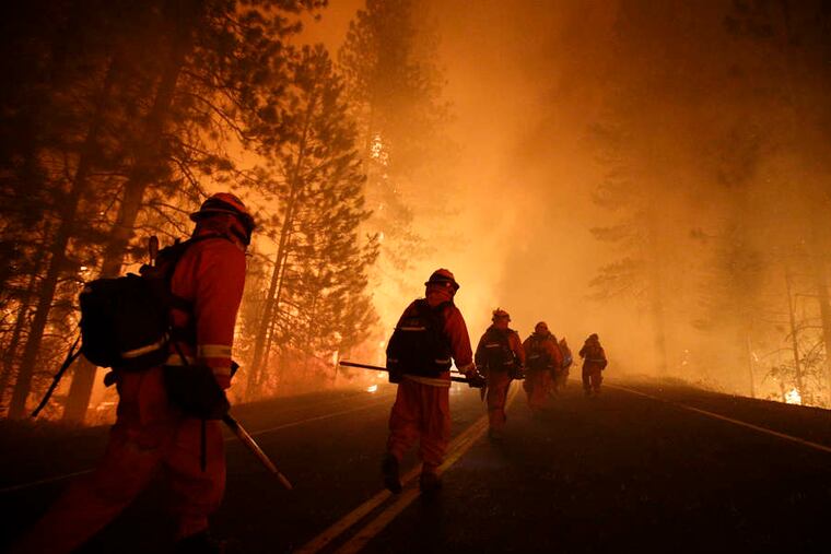 FILE photo shows California inmates fighting the wildfire near Yosemite National Park.