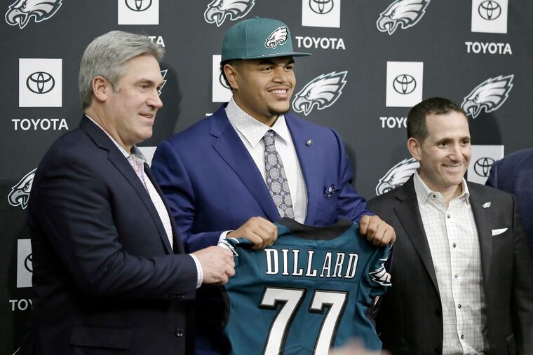 Andre Dillard, the Eagles' first-round pick in 2018, poses for a photo with then-head coach Doug Pederson (left) and vice president of football operations Howie Roseman.