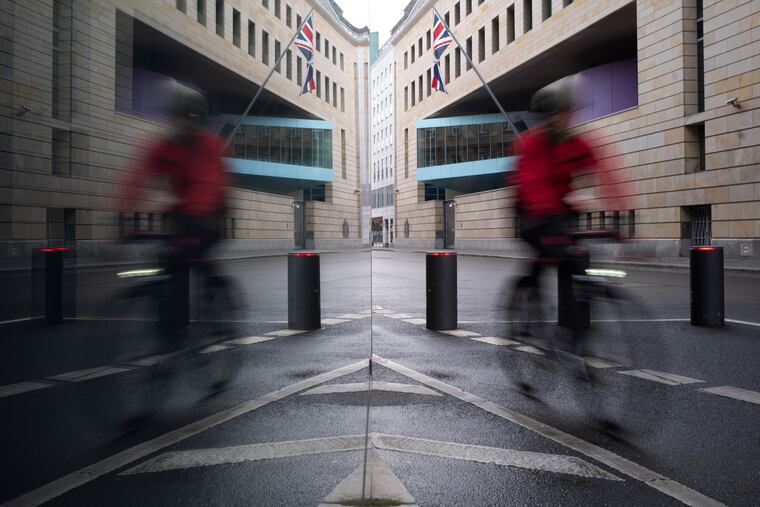 A man rides a bike in front of the British embassy on New Year's Eve in Berlin, Germany, Thursday, Dec. 31, 2020. Eleven months after Britain's formal departure from the EU, Brexit becomes a fact of daily life on Friday, Jan. 1, 2021. (AP Photo/Markus Schreiber)