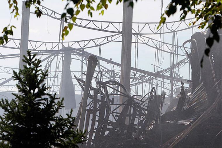 Even with the ruined Dietz & Watson warehouse in Delanco still smoldering from Sunday's fire, company officials say they will be able to shift distribution to other locations, so customers won't miss out on their products. (Akira Suwa / Staff Photographer)