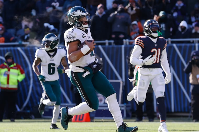 Eagles quarterback Jalen Hurts scores a second quarter touchdown against the Chicago Bears on Sunday, December 18, 2022 in Chicago.