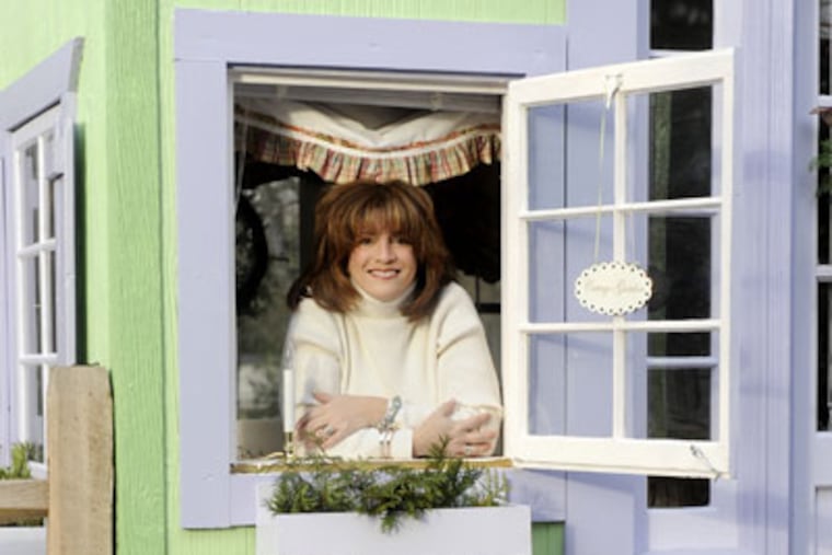 Lyn Steinberg looks out a window of her beautiful little Lavender Nest Cottage which sits behind her house on New Albany St. in Moorestown. ( Clem Murray / Staff Photographer )