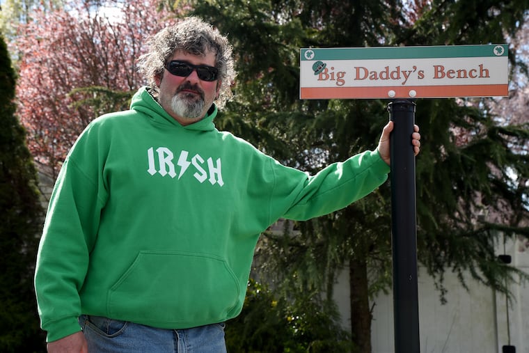 Greg "Big Daddy" Conklin poses with his sign on "Big Daddy's Bench" in front of his house in Gloucester City. What started out as a joke, a gathering place to hang out and take photos, has morphed into something more — the Big Daddy's Bench committee has spearheaded a series of community service drives, and the mayor of the city plans to proclaim a Big Daddy's Bench Day in Gloucester City.