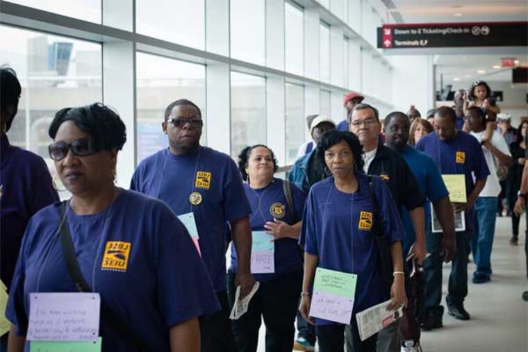 Airport workers and members of Service Employees International Union (SEIU) marched from Philadelphia International Airport's Terminal F to Terminal B, demanding that US Airways Group require subcontractors to pay better wages and benefits. The groups will ask City Council on Tuesday to amend a lease agreement with all airlines and to extend the city's "living wage" standard to 1,500 low-wage airport workers who are employed by subcontractors. (Source: SEIU 32BJ local)