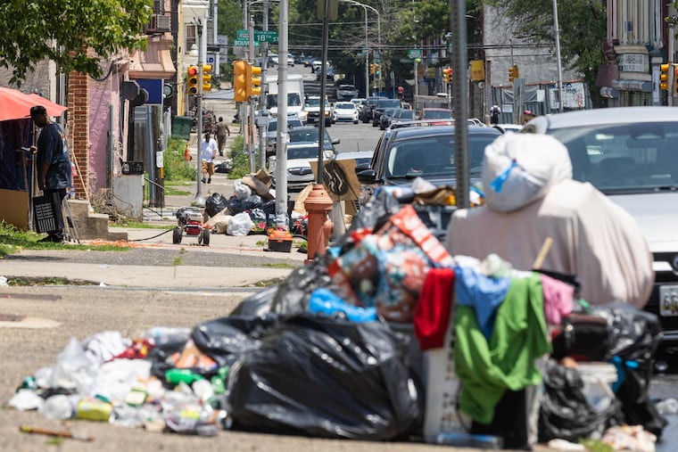 Trash piles up at the curb Saturday along West Susquehanna Avenue in North Philadelphia. It's crucial that the mayor and union leaders return to the bargaining table, the Editorial Board writes.