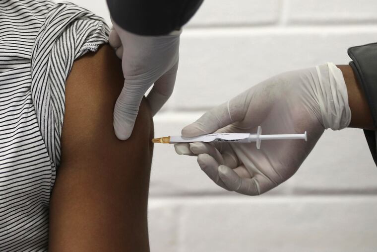In this June photo, a volunteer receives an injection at the Chris Hani Baragwanath hospital in Soweto, Johannesburg. This is part of Africa's first participation in a COVID-19 vaccine trial developed at the University of Oxford in Britain in conjunction with the pharmaceutical firm AstraZeneca.