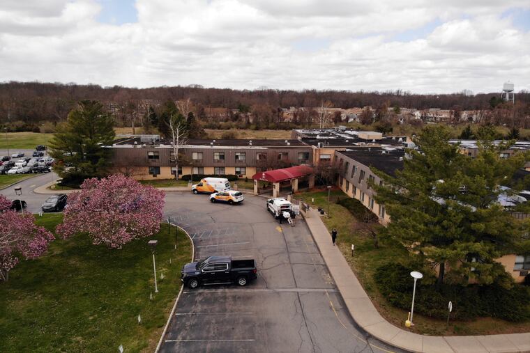 Ambulance crews are parked outside Andover Subacute and Rehabilitation Center in Andover, N.J., on Thursday.
