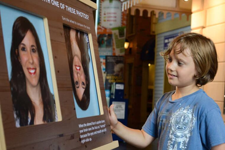 Judah McCollum , 7, gives an optical-illusion display a workout.