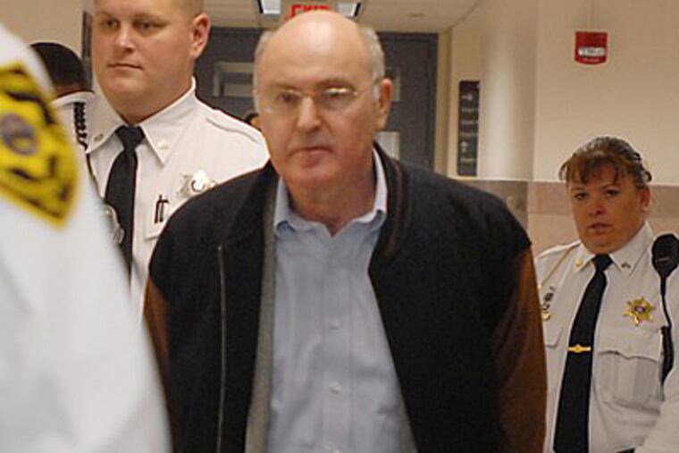 FILE PHOTO: Rafael Robb, 58, is led to his sentencing hearing in a Montgomery County courtroom. Robb pleaded guilty last year to voluntary manslaughter in his wife's 2006 beating death.