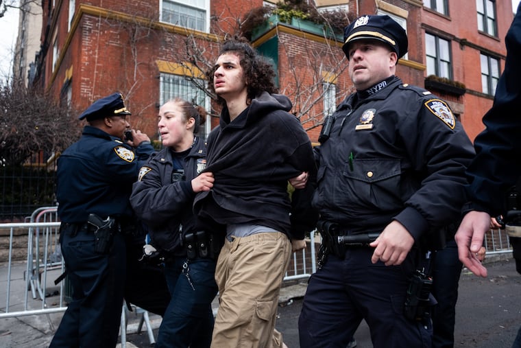 Police detain Emir Balat after police say he attempted to detonate an improvised explosive device during a counterprotest against far right influencer Jake Lang staging an anti-Islam protest outside Gracie Mansion on Saturday.