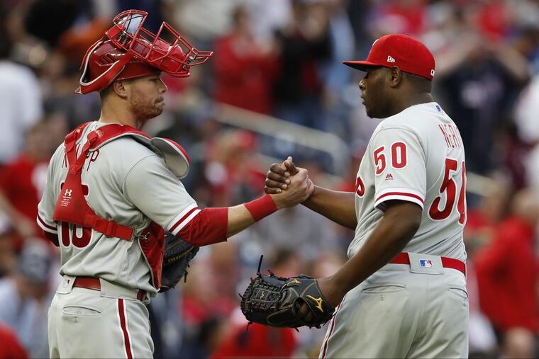 Phillies closer Hector Neris celebrates with catcher Andrew Knapp after Neris struck out the Nationals’ Wilmer Difo to end the game on Saturday in Washington, D.C.