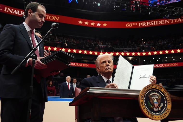 White House staff secretary Will Scharf watches as President Donald Trump signs an executive order at Capital One Arena on Jan. 20 in Washington.