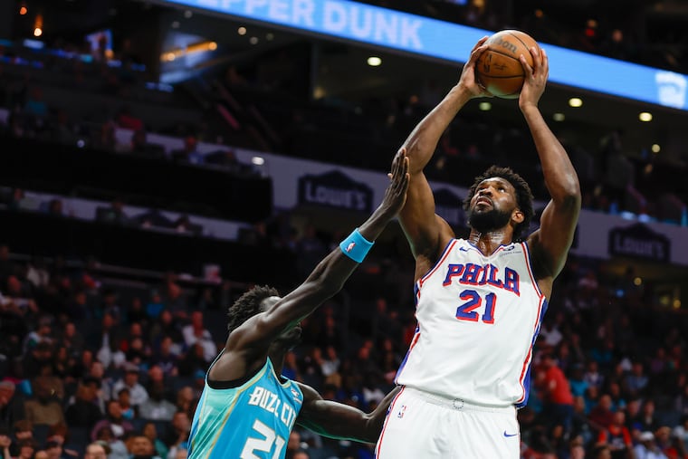 Sixers center Joel Embiid (right) shoots over Charlotte Hornets forward JT Thor in the second half. The reigning MVP racked up 42 points in just three quarters of action.