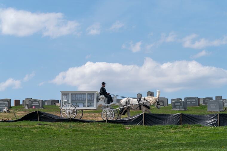 A carriage with the casket of Devin Weedon arrives at Fernwood Cemetery.