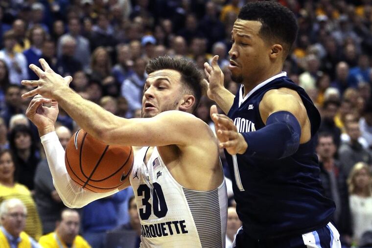 Marquette's Andrew Rowsey loses the ball while being guarded by Villanova's Jalen Brunson during the first half.