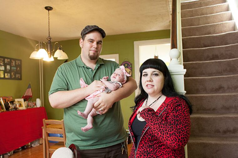 Furloughed park rangers Patrick and Lisa Honan with their infant daughter Alice Elizabeth at home in Bridgeport, on Tuesday October 8, 2013. ( Ed Hille / Staff Photographer )