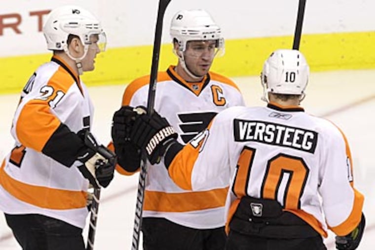 Mike Richards celebrates his second-period goal with James van Riemsdyk and Kris Versteeg. (AP Photo)