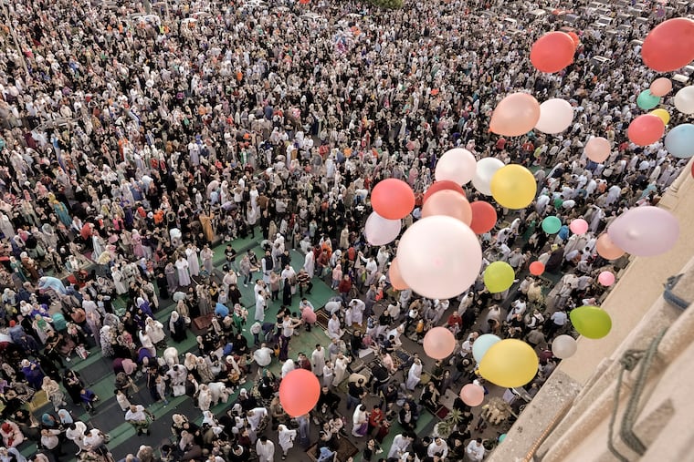 Balloons are distributed for free after Eid al-Fitr prayers outside al-Seddik mosque in Cairo, Egypt, on Friday.