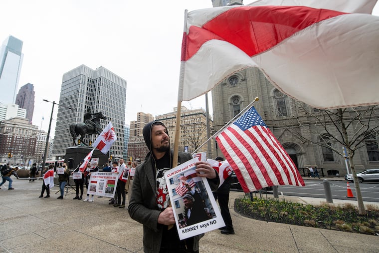 Jauhien Sasnou raises a historic Belarusian flag during a protest on Friday to express disagreement with the city's decision to deny the flag-raising ceremony application.