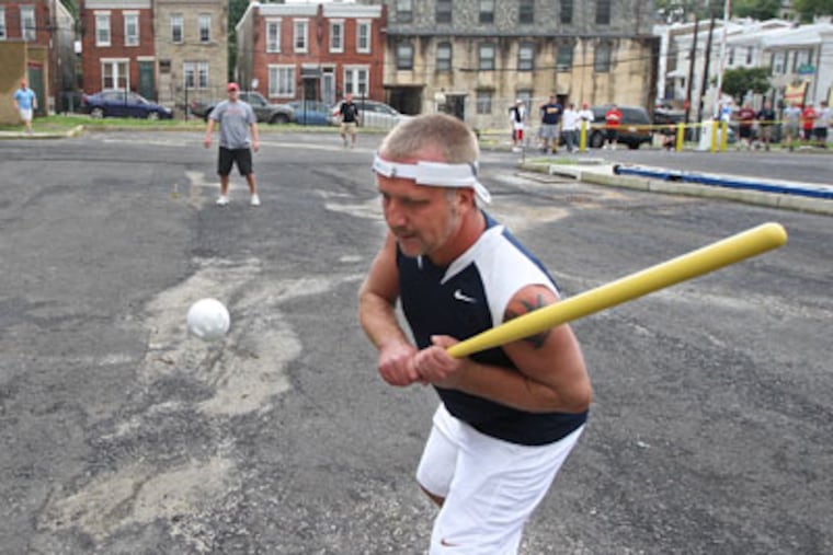 Warren Whitehouse watches the ball go over the plate and hit the backstop. Wiffle ball participation by adults has grown tremendously over the last five years. (Michael Bryant / Staff Photographer)