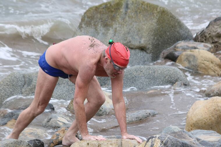 Anthony McCarley, 54, of Berwyn, emerges from the Pacific Ocean after swimming 20 miles from Catalina Island to the California mainland on Saturday. This was his third and final leg of what is known as the Triple Crown of marathon swimming. He crossed the English Channel last August, and swam 28 miles around Manhattan June 28. Photo provided Mr McCarley