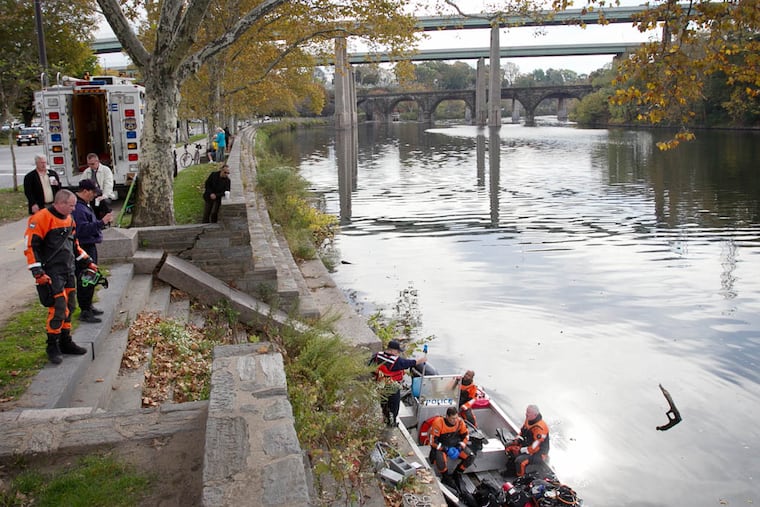 Philadelphia police prepare to search the Schuylkill River at Midvale and Kelly Drive on Tuesday morning for gun allegedly connected to a homicide. Photograph taken on Tuesday morning October 28, 2014. (ALEJANDRO A. ALVAREZ / STAFF PHOTOGRAPHER )