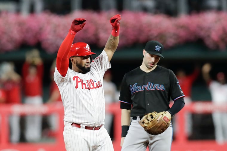 Neil Walker, then with the Marlins, next to the Phillies' Deivy Grullon during a September game.