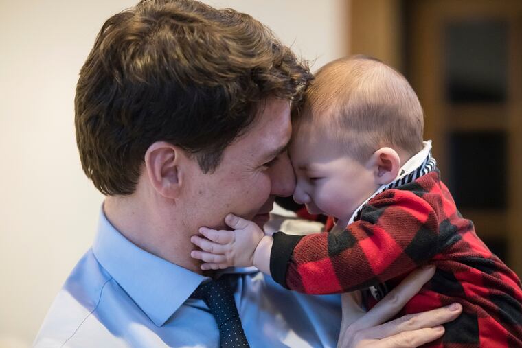 Prime Minister Justin Trudeau holds Jack Golden, 6 months old, while campaigning with Richard T. Lee, the Liberal candidate in the Burnaby South byelection, at a cafe in Burnaby, British Columbia, Monday, Feb. 11, 2019. (Darryl Dyck / The Canadian Press via AP)