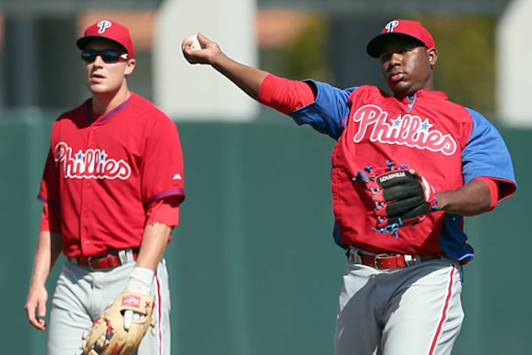 Phillies third baseman Cody Asche (left) and prospect Maikel Franco (right). (Yong Kim/Staff file photo)
