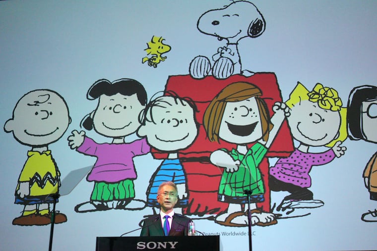 Then-Sony Corp. president Kenichiro Yoshida speaks as characters from "Peanuts" are shown at a news conference at the company's headquarters in 2018 in Tokyo.