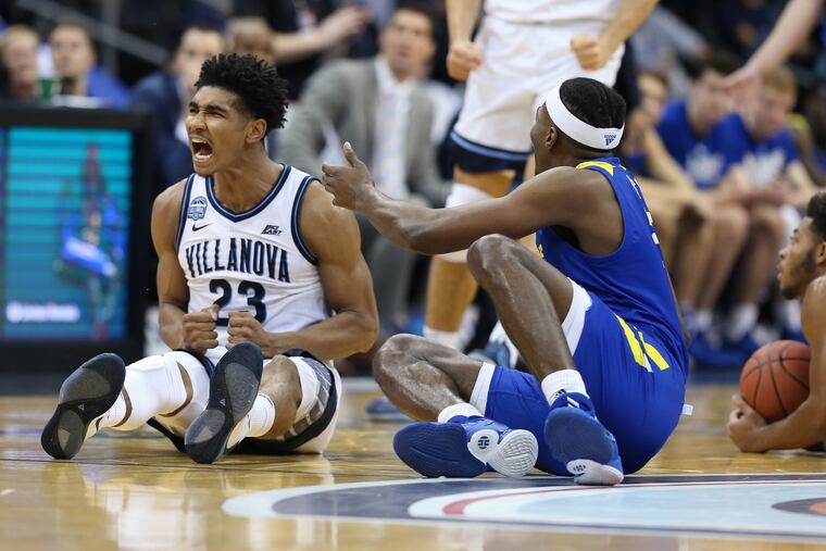 Jermaine Samuels, left, of Villanova celebrates after forcing a turnover agains Delaware in the second half of their matchup at the Prudential Center in Newark this past Saturday.