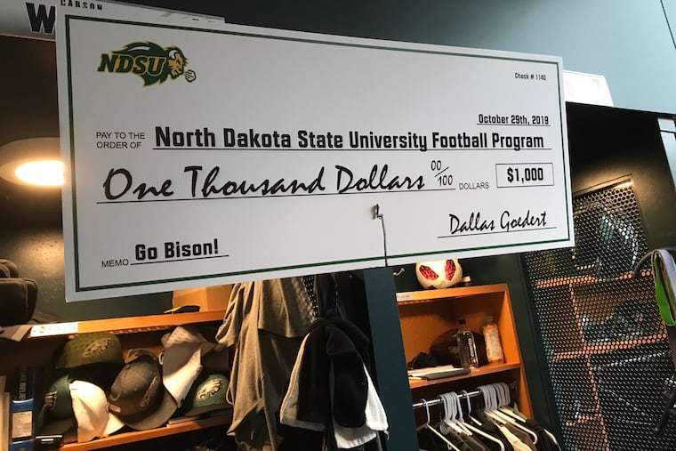 A larger-than-life check from Eagles tight end Dallas Goedert to the North Dakota State football program for $1,000. Goedert lost a bet with Bison alum Carson Wentz.