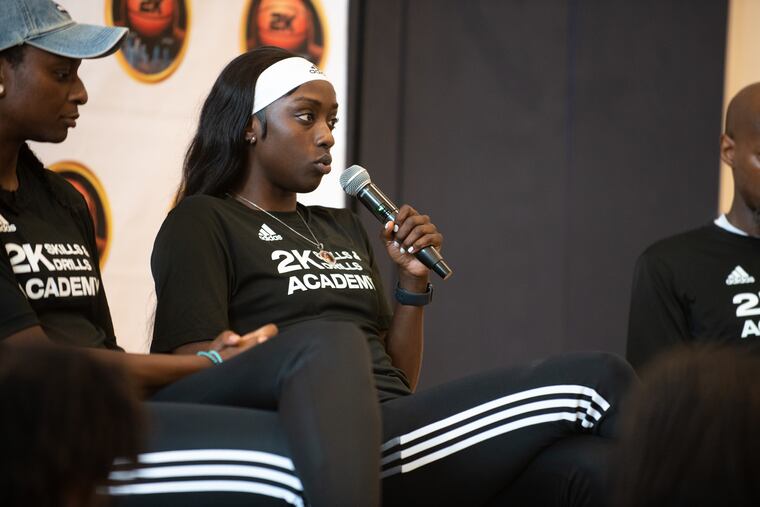Keisha Hampton (left) and Philly native Kahleah Copper speak to players during the 2K Skills and Drills Academy on Saturday at Cristo Rey High School.