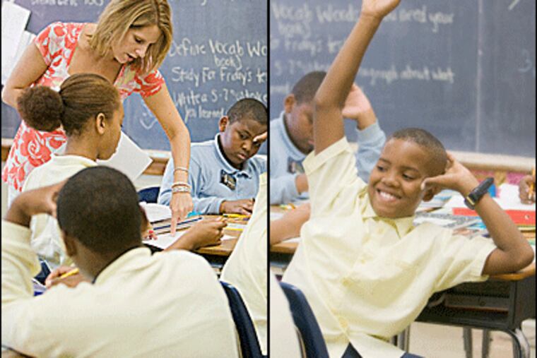 Teacher Eileen Hoffman works with fifth-grade students at F.S. Edmonds School. At right, student Michael Campbell raises his hand. Photos by (JESSICA GRIFFIN / Staff Photographer)