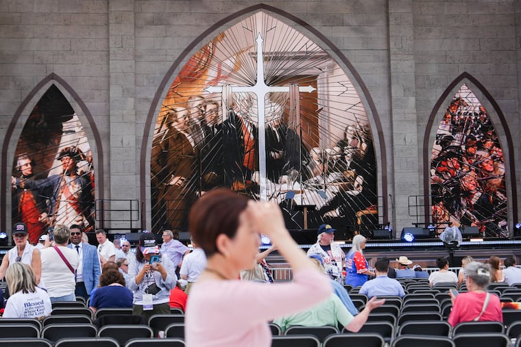 A person prays during Rededicate 250, a mostly conservative Christian prayer gathering in honor of the United States' 250th anniversary, on the National Mall, Sunday, May 17, 2026, in Washington.