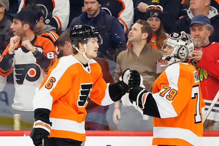 Flyers defenseman Travis Sanheim celebrates his first period goal with teammate goaltender Carter Hart against the Colorado Avalanche on Monday, December 5, 2022 in Philadelphia.