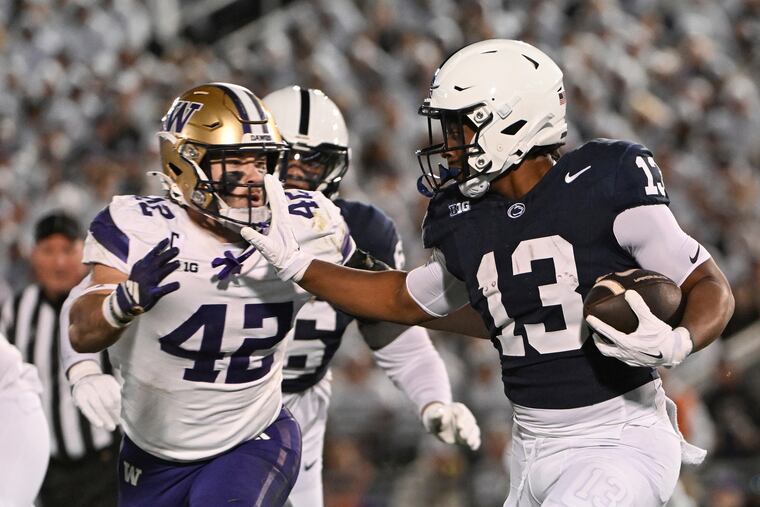 Penn State running back Kaytron Allen stiff-arms Washington linebacker Carson Bruener during the first quarter Saturday.
