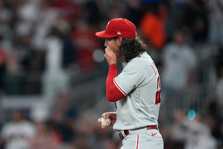 Phillies relief pitcher Michael Lorenzen reacts after giving up a two-run double to the Braves' Marcell Ozuna in the fifth inning. Lorenzen could only record one out on Tuesday night.