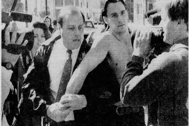 A shirtless Edward Leigh Hunt Jr. is surrounded as he gives himself up to FBI agents in Los Angeles.