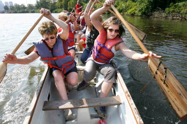 Jan Webb (left), Bridget Clark, and other members of the Old York Road Temple–Beth Am crew practice in their dragon boat on the Schuylkill.